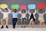 Speech bubble, business people together and smile on chair for recruitment, hiring and diversity in office. Corporate group, businessman and women with opinion, portrait and team building with poster