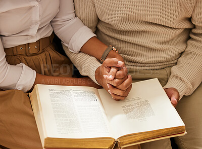 Buy stock photo Bible, holding hands and reading with a black couple together in the home for religion, faith or belief in God. Jesus, pray or book with a christian man and woman learning about the spiritual christ