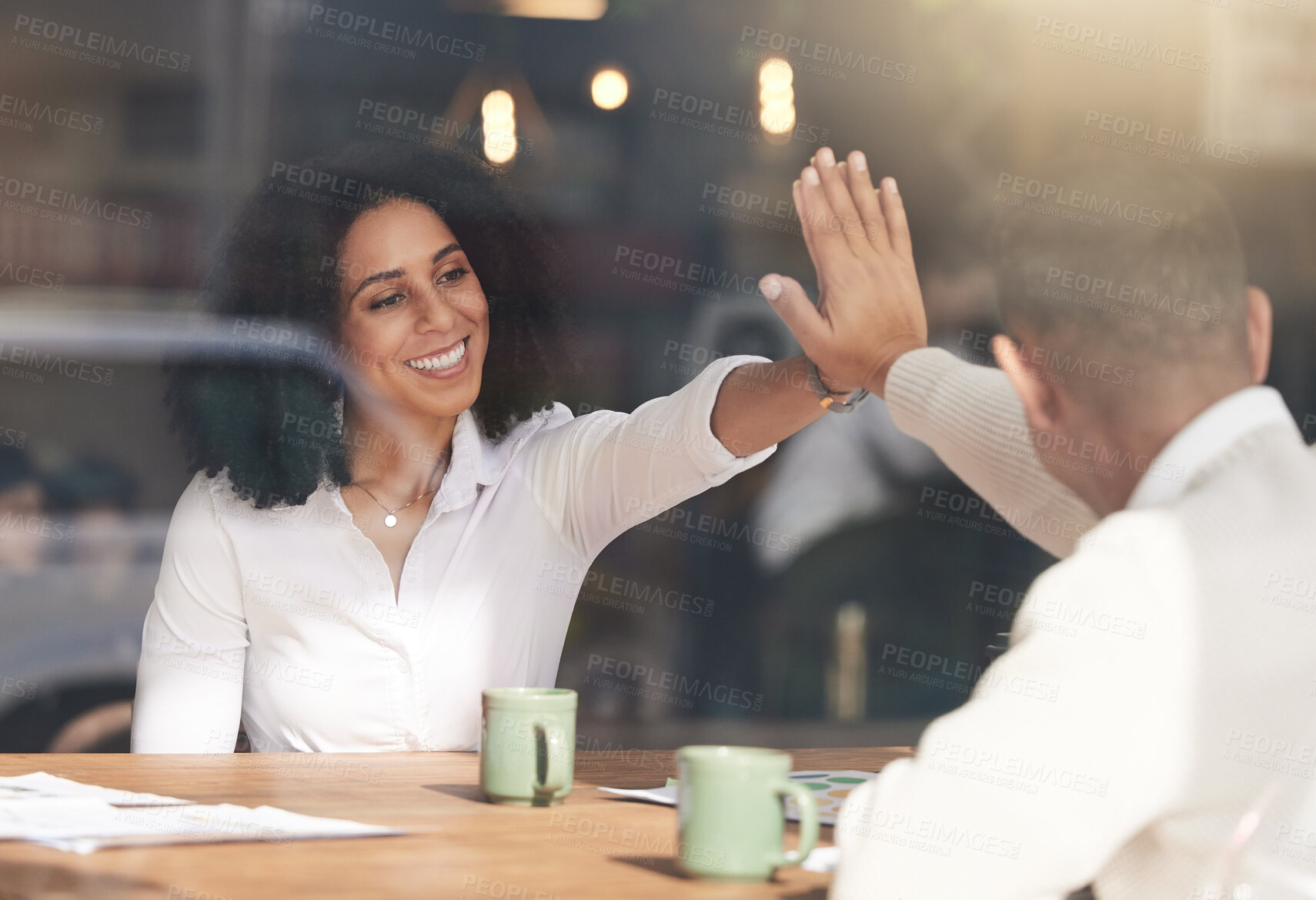 Buy stock photo Business people, high five and celebration in meeting for planning, team collaboration or success at cafe. Black woman touching hands with colleague for teamwork, partnership or b2b at coffee shop