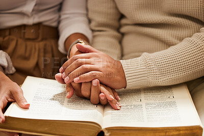 Buy stock photo Closeup, hands and couple with bible, praying and support with love, spiritual and religious practice. Zoom, hand and man with woman, prayer and scripture for faith, trust and wellness with bonding
