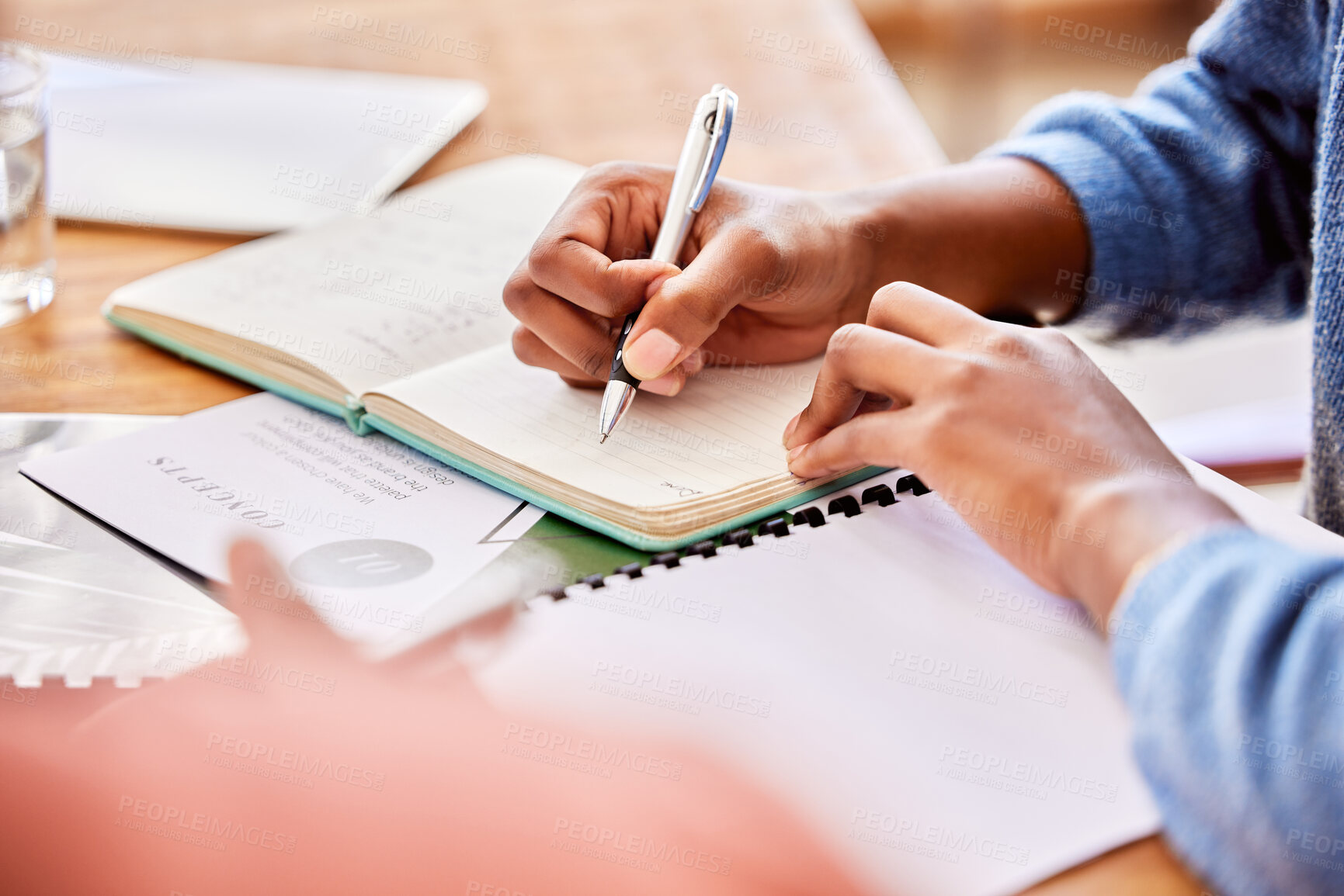 Buy stock photo Meeting, discussion and team planning a project while writing creative notes in the office. Collaboration, teamwork and people brainstorming with notebooks while working on report in the workplace.