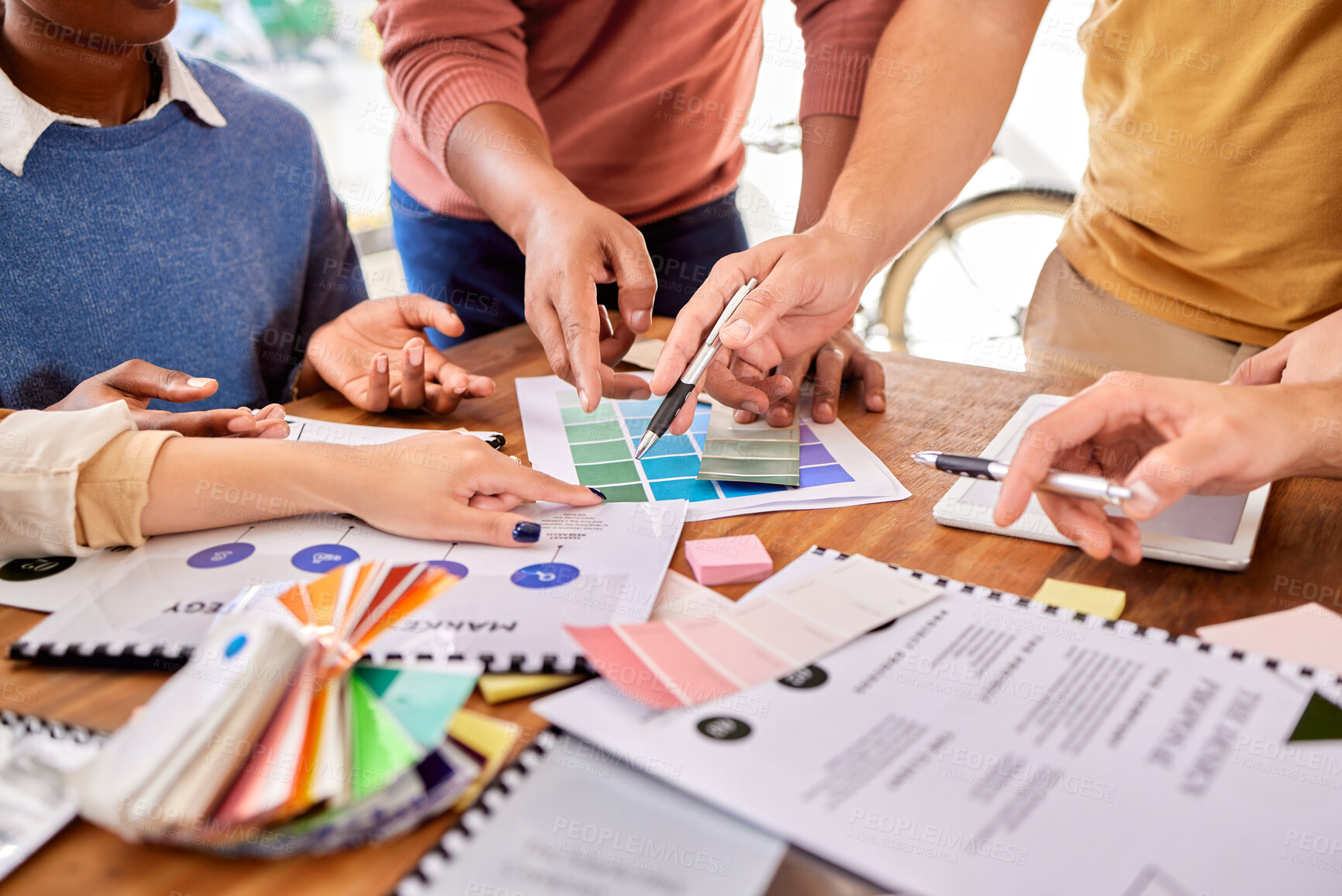 Buy stock photo Hands, documents and strategy with a designer team working on a creative project together in the office. Meeting, data and marketing with a group of design people at work in the boardroom closeup