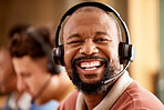 Face, portrait and smile of black man in call center for customer service work in office. Crm consulting, sales agent and happy telemarketer, representative or male consultant laughing at funny joke.