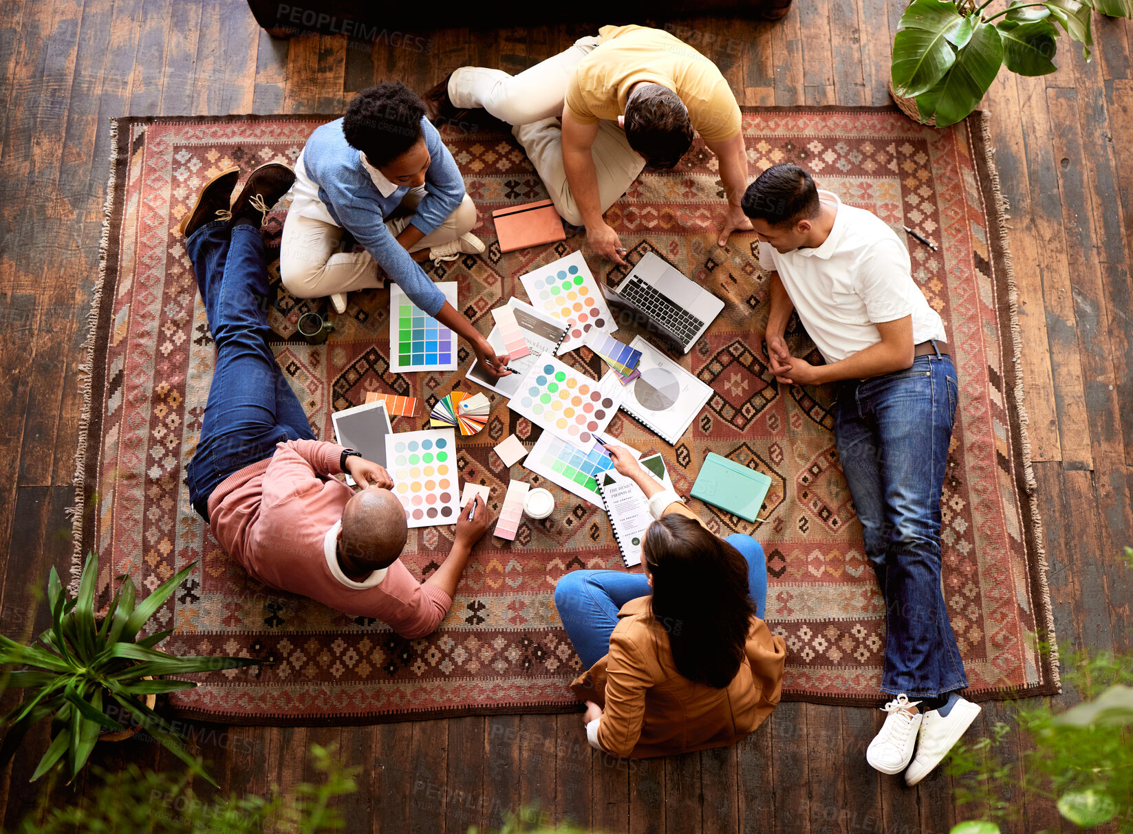 Buy stock photo Collaboration, creative and overhead with a designer team lying on the floor while working on a project. Teamwork, startup or ideas with a group of young people working in advertising or marketing