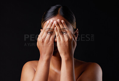 Buy stock photo Hiding, shame and portrait of a woman covering face isolated on a black background in a studio. Shy, fear and girl with hands to cover eyes, an expression or insecurity about skin on a dark backdrop