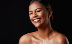 Skincare, funny and black woman with smile, dermatology and joyful against dark studio background. Cosmetics, African American female and lady with happiness, laughing and wellness with shine or glow