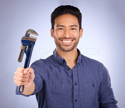 Buy stock photo Man, smile and portrait with tools or wrench for handyman, maintenance or repair work in studio. Happy asian model person on purple background show spanner for engineer, mechanic or technician job