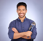 Man, studio and portrait with tools or wrench for handyman, maintenance or repair work with smile. Happy asian model person on purple background with spanner for engineer, mechanic or technician job