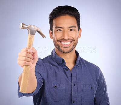 Buy stock photo Construction, showing and portrait of an Asian man with a hammer isolated on a studio background. Building, happy and builder with a tool for repairs, maintenance and handyman work on a backdrop