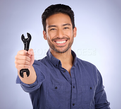 Buy stock photo Portrait of man with wrench tool isolated on studio background for repair solution, maintenance or plumbing. Professional worker, asian person or happy plumber hand with mechanic gear for job success