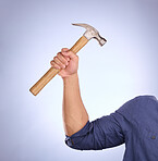 Hammer, construction worker tool and hand in a isolated, blue background and studio. Handyman, house building and maintenance contractor career with man hands holding a builder and repair tools