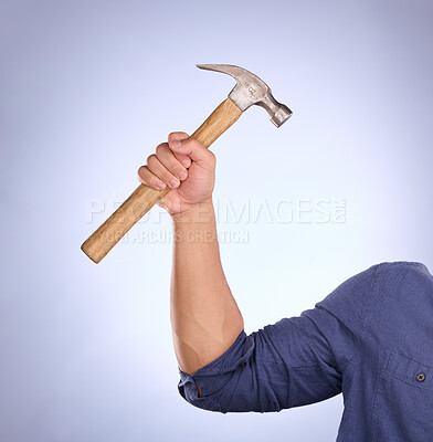 Buy stock photo Hammer, construction worker tool and hand in a isolated, blue background and studio. Handyman, house building and maintenance contractor career with man hands holding a builder and repair tools