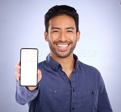 Buy stock photo Business asian man, phone and smile with mockup for social media, advertising or marketing app against studio background. Portrait of happy male showing smartphone screen for display advertisement