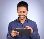 Happy business man on tablet isolated on studio background for stock market research with online app. Happy asian person, worker or entrepreneur on digital technology for profit, sales and fintech