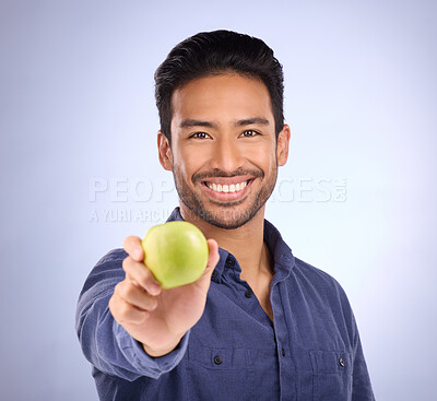 Buy stock photo Portrait of happy man with apple isolated on studio background healthy diet, healthcare or nutritionist breakfast. Vegan person or asian model with green fruit or food for dietician care and choice