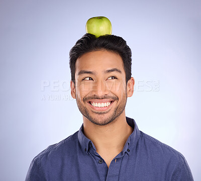 Buy stock photo Head, apple and Asian man with smile, balance and healthy lifestyle against a grey studio background. Male, Japan and guy with fruit, diet or thinking with happiness, cheerful or joyful with wellness