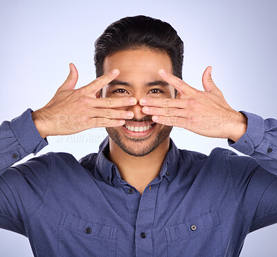 Buy stock photo Hiding, funny and portrait of an Asian man with a hand isolated on a studio background. Comic, crazy and Japanese person covering the face for humor, shy expression and gesture on a backdrop