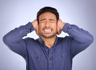 Buy stock photo Stress, noise and man closing his ears in studio isolated on a gray background. Loud, mental health and upset, angry or mad business person with headache, depression or anxiety from noisy sound.