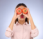 Woman, tomato and covering eyes in studio for healthy food, vegan diet and vegetable in hands. Face of a model person with red vegetables for health, wellness and skin care on purple background