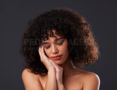 Buy stock photo Natural, beauty an hands on face by black woman in studio for hair, treatment and body care on black background. Soft, skin and girl model relax with luxury, smooth and glowing results while isolated