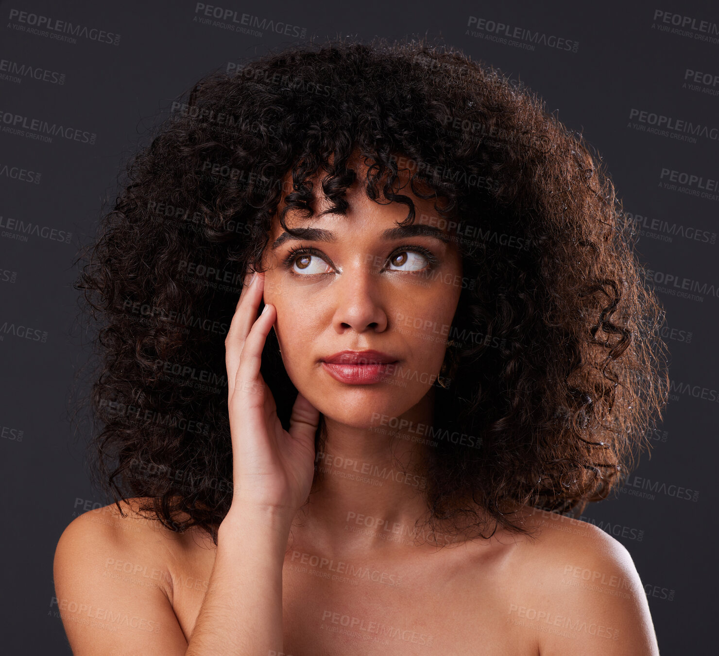 Buy stock photo Natural, beauty and black woman in studio for hair, treatment or body care on black background. Face, hand and girl thinking, curly and afro model relax in luxury, soft or glowing skin while isolated