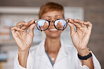 Optometry, hands and doctor with glasses in hospital or clinic for ophthalmology. Vision, healthcare and happy woman or medical optician with spectacles, frames or lenses for eye care and wellness