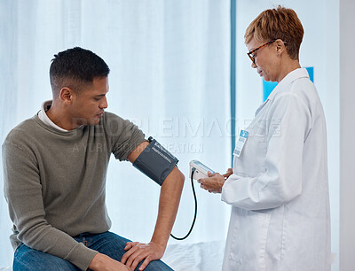 Buy stock photo Doctor, test and man with blood pressure in hospital for heart health or wellness consultation. Hypertension, healthcare or senior medical physician with patient for examination with sphygmomanometer