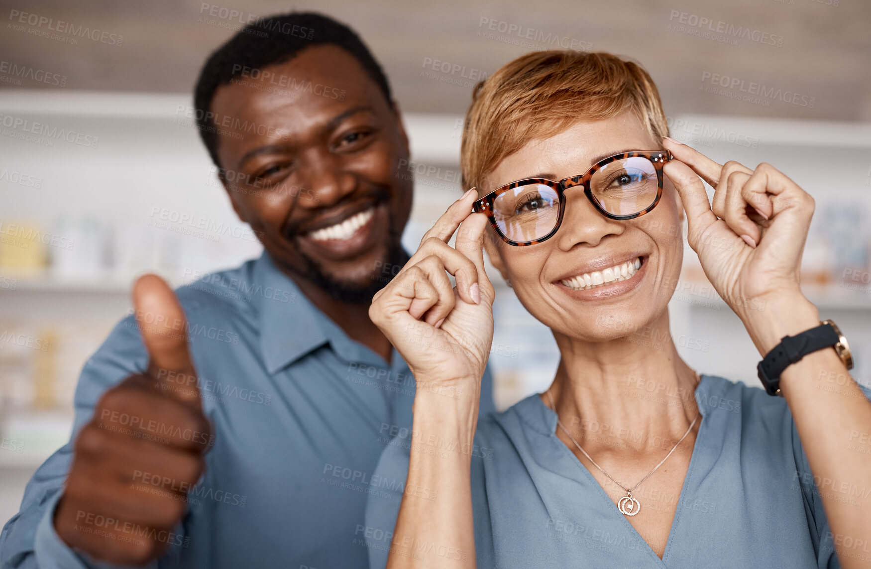 Buy stock photo Thumbs up, optometry and woman with glasses for vision or wellness in optics store. Healthcare portrait, hand emoji or smile of happy elderly female with black man or optometrist with success gesture