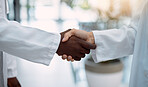 Doctor, handshake and partnership in healthcare, agreement or deal for collaboration, teamwork or unity. Hand of medical professionals shaking hands for meeting, greeting or success in solidarity
