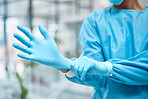 Medical gloves, medical gear and doctor hand in a wellness and health clinic ready for surgery. Safety, research and laboratory hygiene of a healthcare and nurse employee with blurred background