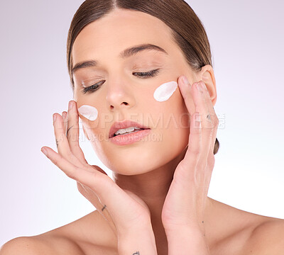Buy stock photo Beauty, skincare or girl with face cream product in daily grooming treatment with makeup cosmetics in studio. Dermatology, mockup space background or female model applying facial sunscreen lotion 