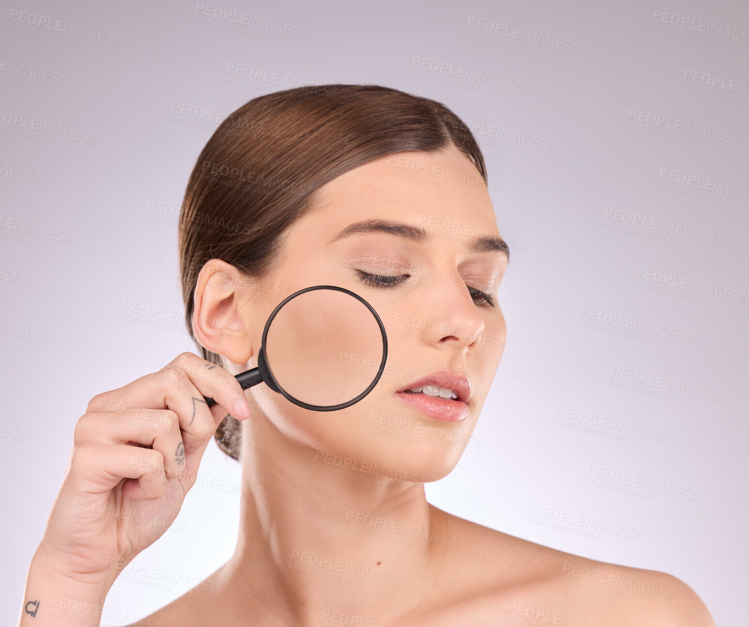 Buy stock photo Woman, magnifying glass and face in studio for beauty, cosmetics and dermatology. Facial magnifier, female model and check skincare, aesthetic wellness and inspection for acne, laser and search pores