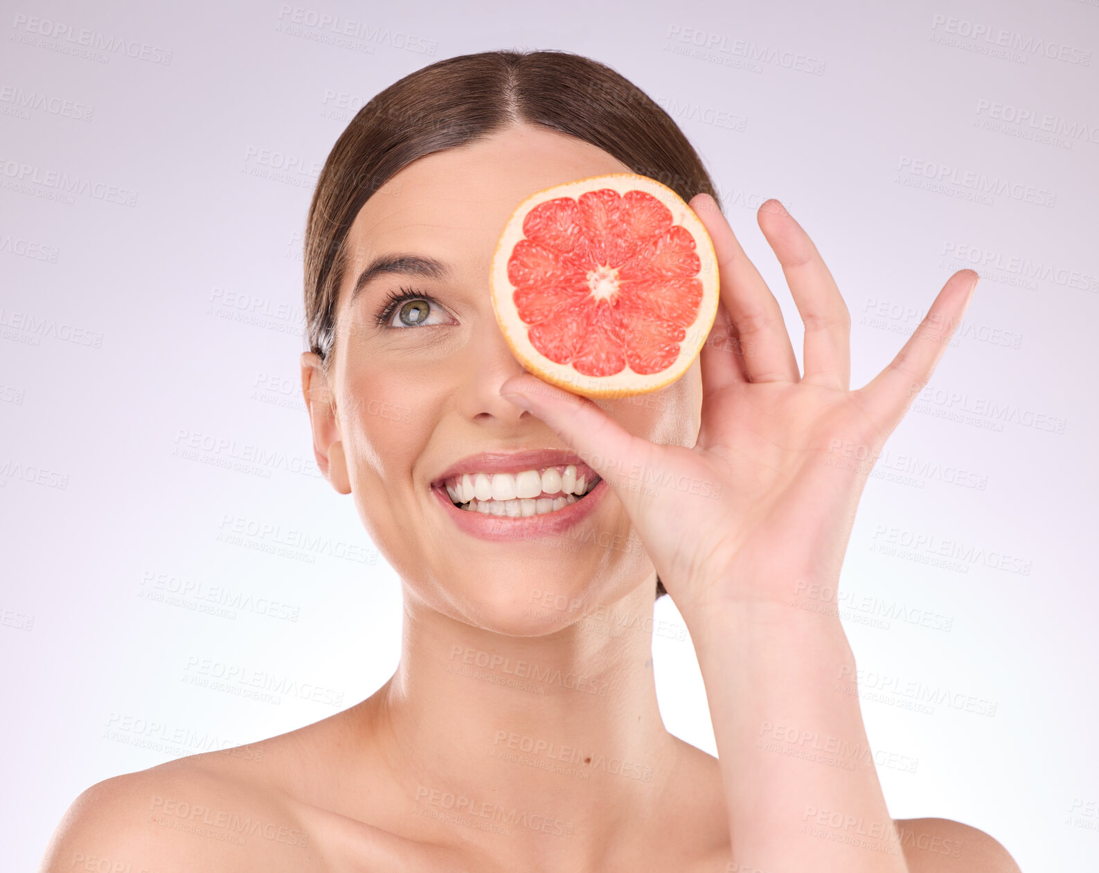 Buy stock photo Woman, face and hand with grapefruit for skincare nutrition or healthy diet against gray studio background. Portrait of happy female smile with fruit for organic vitamin C facial or natural cosmetics