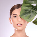 Woman, portrait and monstera leaf for beauty, natural cosmetics and aesthetic wellness on studio background. Face, model and skincare from plants, green leaves and sustainability of vegan dermatology