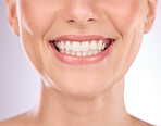 Teeth, dental and oral hygiene with a model woman in studio on a gray background for tooth whitening. Dentist, healthcare and veneers with a female indoor to show a happy smile at a mouth specialist