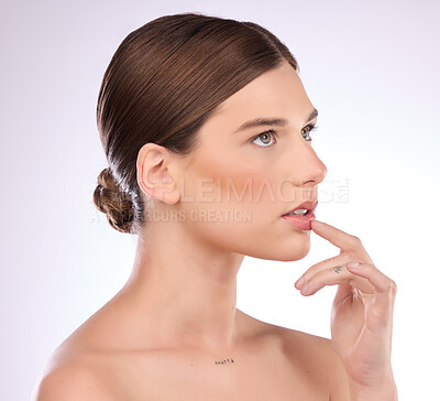 Buy stock photo Beauty, thinking and lips with a model woman in studio on a gray background for natural skincare or cosmetics. Luxury, wellness and transformation with an attractive young female touching her mouth