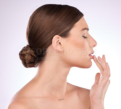 Buy stock photo Beauty, skincare and lips with a model woman in studio on a gray background for natural skin cosmetics. Luxury, wellness and transformation with an attractive young female touching her mouth