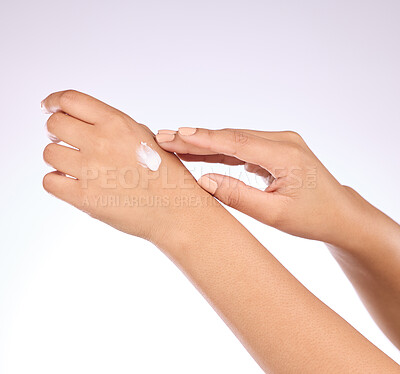 Buy stock photo Hands, cream and beauty, skincare and woman, manicure and nail polish with cosmetics on studio background. Sunscreen, moisturizer application and dermatology with lotion cosmetic product and female
