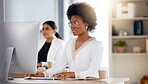 Serious black woman, computer and working in focus checking corporate database or finance at office desk. African American female sitting by desktop PC for email or communication at the workplace