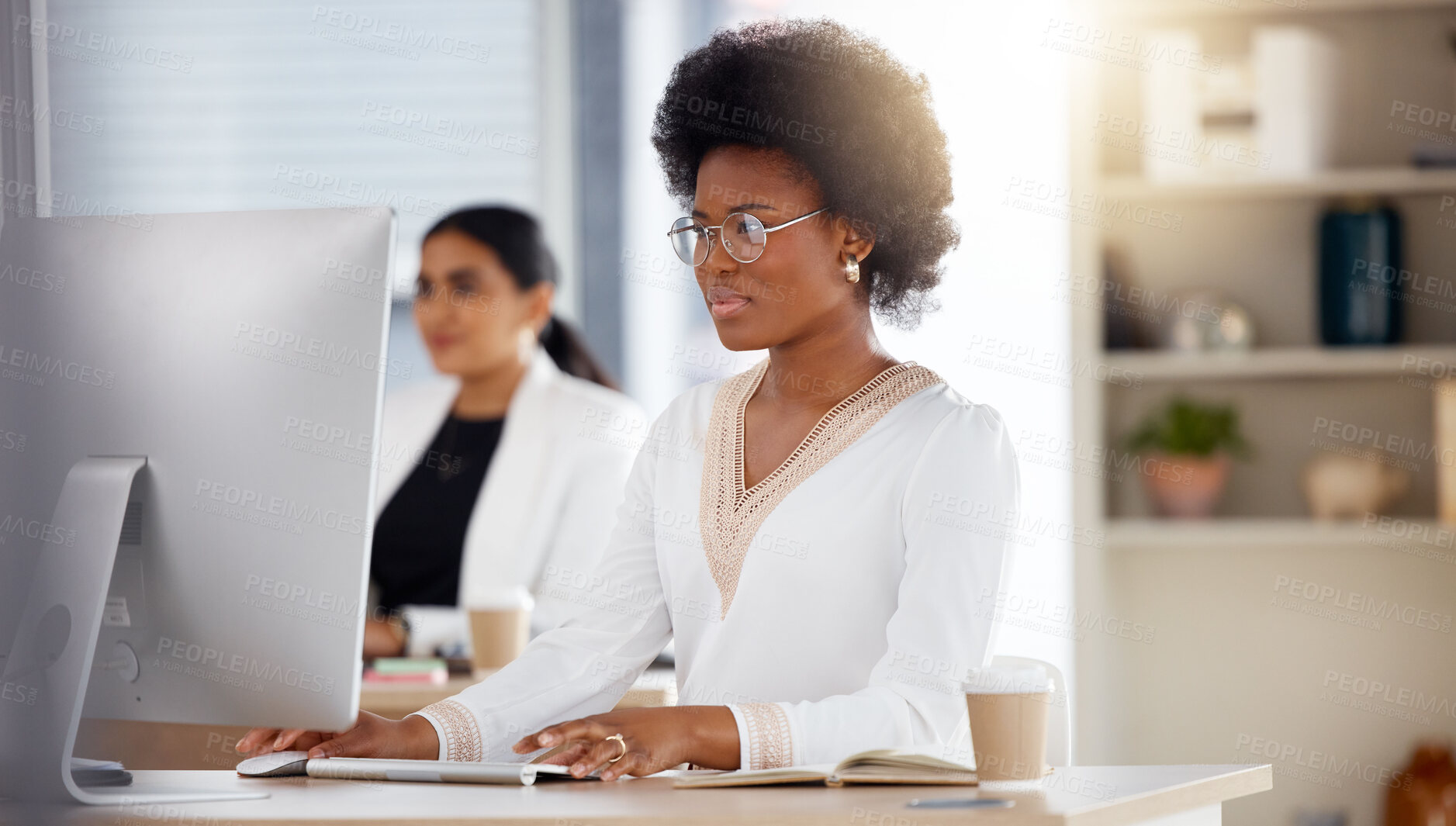 Buy stock photo Serious black woman, computer and working in focus checking corporate database or finance at office desk. African American female sitting by desktop PC for email or communication at the workplace