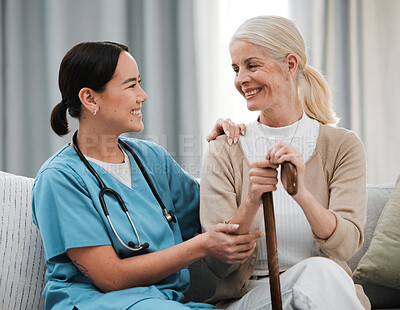 Buy stock photo Nurse, senior woman and sofa with support, walking stick and smile together with happiness, chat and care. Elderly patient, asian doctor and couch with helping hand, happy and solidarity connection