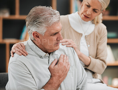 Buy stock photo Heart attack, pain and senior couple at home with cardiology problem or stroke. House, cardiac arrest and retirement of a man with emergency and health issue in a living room with female support