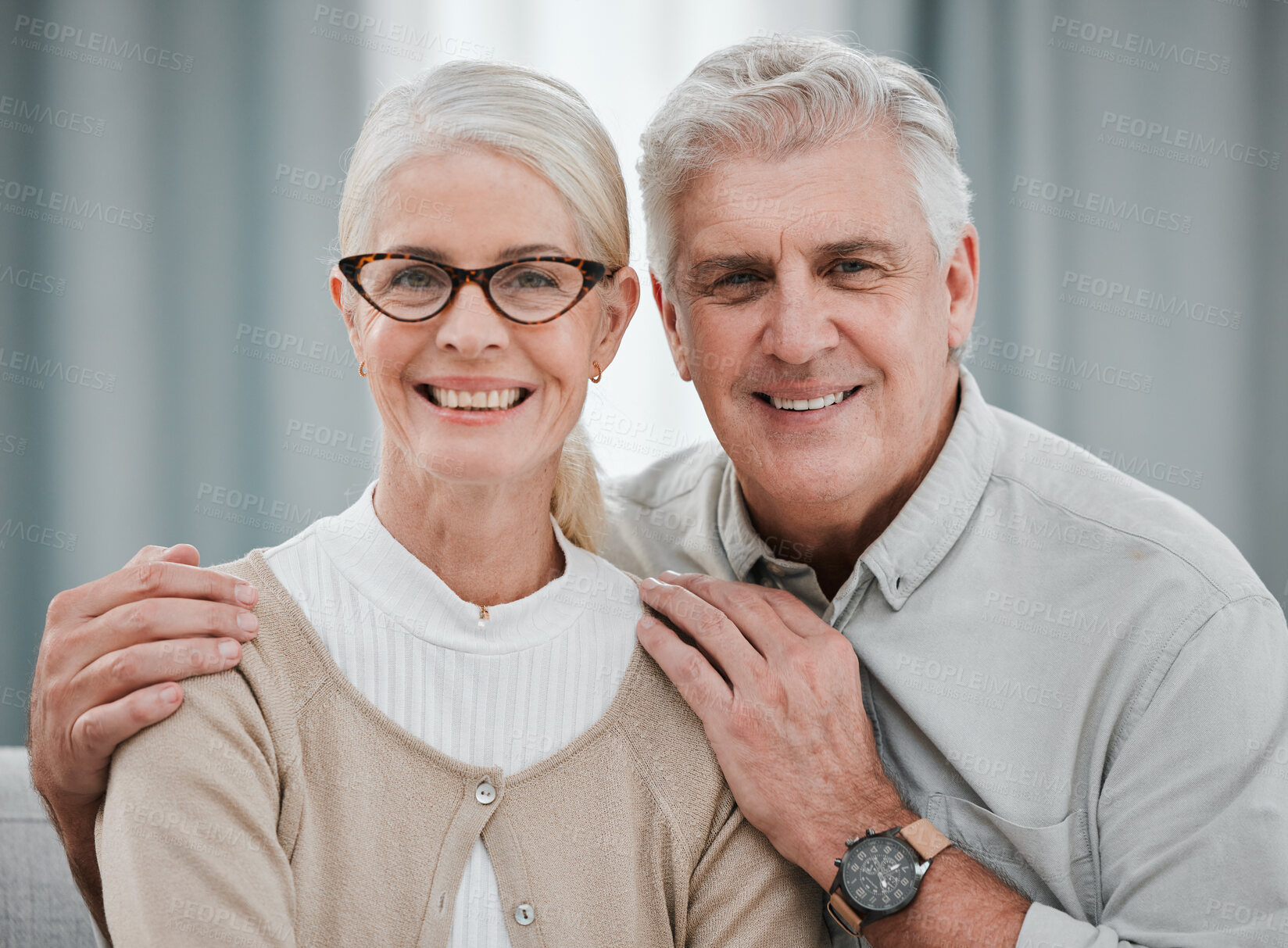 Buy stock photo Portrait, love or commitment with a senior couple hugging in the living room of their house together. Smile, space or trust with a happy mature man and woman bonding while enjoying retirement at home