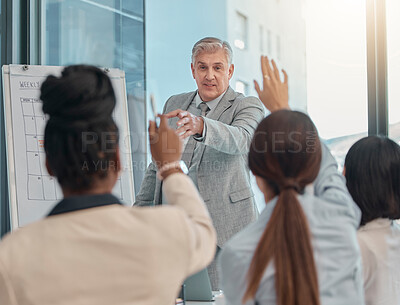 Buy stock photo Senior businessman, coaching and presentation with question in team collaboration or engagement at office. Elderly male CEO leader or coach training staff with hands raised in FAQ, teamwork or answer