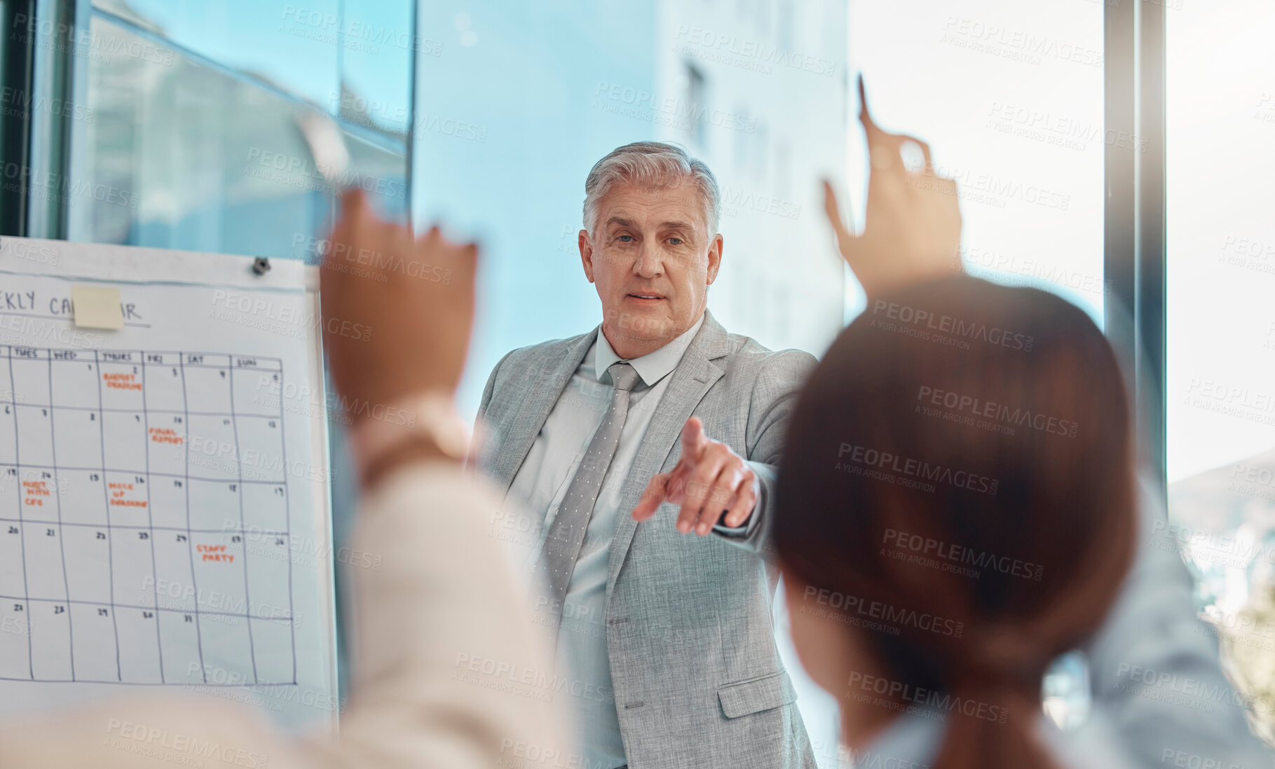 Buy stock photo Senior businessman, coaching and question in team presentation for collaboration or engagement at office. Elderly male CEO leader or coach training staff with hands raised in FAQ, teamwork or meeting