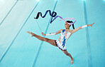 Gymnastics, woman with ribbon for dance and sport performance, flexibility with professional athlete in gym and top view. Rhythmic gymnast, leg in air with fitness, grace and action with dancing
