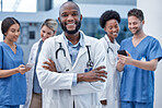 Black man, doctor and portrait with arms crossed in hospital, clinic and surgery of leadership. Happy medical worker smile for consulting service, expert therapist and trust in healthcare management 