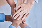 Business people, diversity and hands together above in trust, partnership or collaboration at the office. Group of diverse employee workers piling hand in teamwork, support or agreement in solidarity