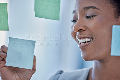 Buy stock photo Planning, brainstorming and black woman writing a schedule on a sticky note, agenda or a work goal. Research, creative and African employee with a strategy, solution or idea for a project on paper