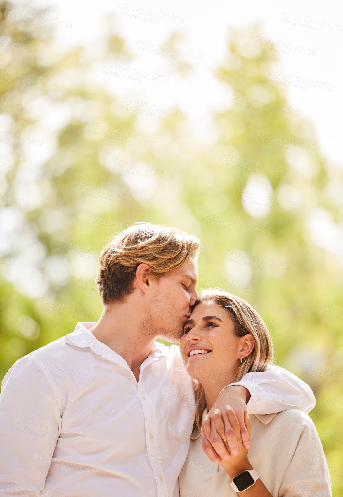 Buy stock photo Hug, love and couple kiss for happy, quality time and bonding on weekend, vacation and holiday. Summer, dating mockup and young man and woman hugging, kissing and romantic embrace in nature park